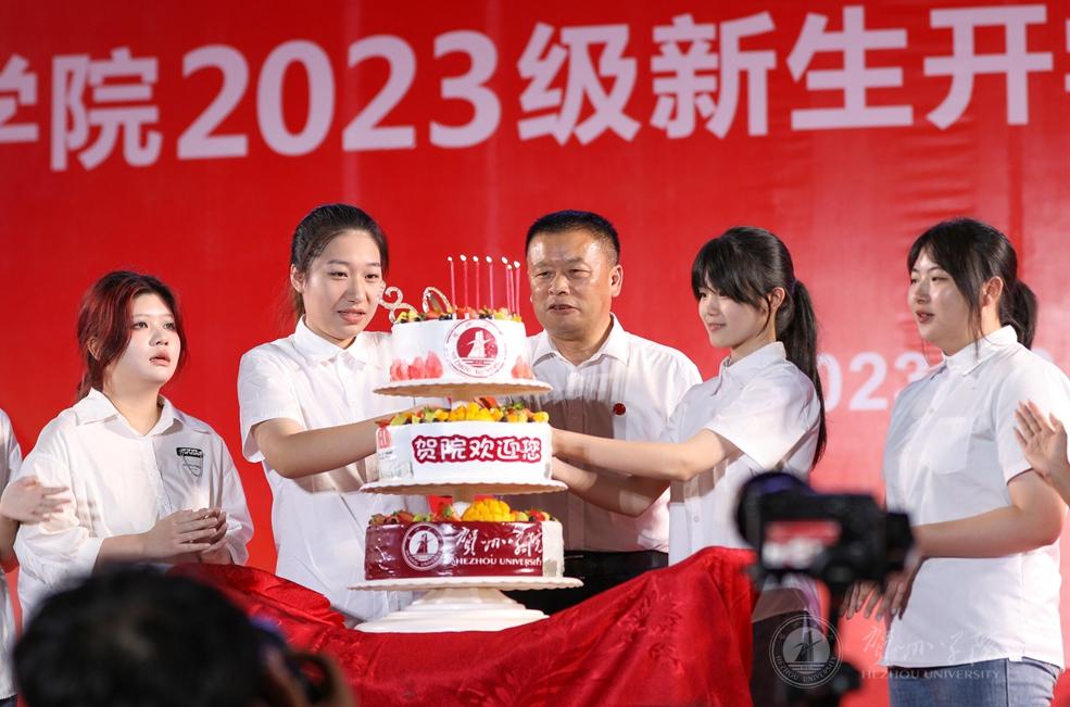 王源平与过生日的2023级新生共同切蛋糕